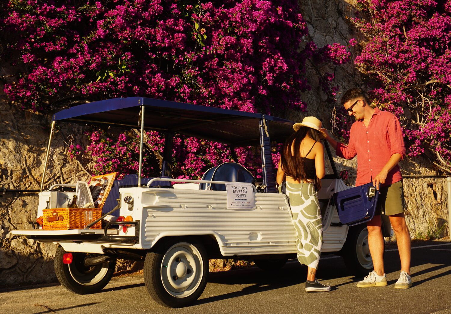 Vintage Citroën Méhari framed by pink bougainvillea on the French Riviera